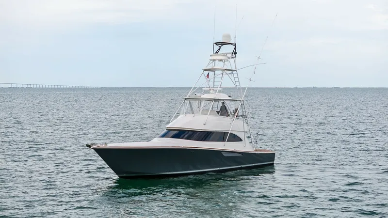 Slide: The Image of Viking 55 Convertible Profile View This image showcases the sleek profile of the Viking 55 Convertible, highlighting its robust and stylish design. The vessel features a spacious flybridge with a tuna tower, perfect for sport fishing enthusiasts. The hull's elegant lines and advanced engin - 7584926