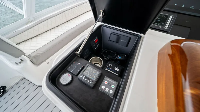Slide: The Image of Helm Station Control Panel The helm station of the 2015 Viking 55 Convertible features a sleek control panel with advanced navigation instruments. The panel is neatly organized, offering easy access to essential controls and electronics. Finished with high-quality materials and a p - 7584908
