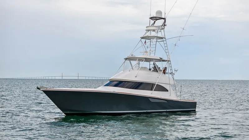 Slide: The Image of Exterior Profile with Tower The 2015 Viking 55 Convertible 'Rosita' showcases a sleek and powerful exterior, highlighted by its distinctive sportfishing tower. The vessel's deep-V hull ensures a smooth ride, while the expansive flybridge offers excellent visibility and ample space f - 7584925
