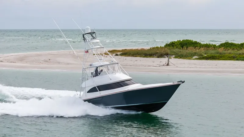 Slide: The Image of Dynamic Bow View in Motion The 2015 Viking 55 Convertible showcases its sleek design and powerful performance as it cuts through the water effortlessly. The sharp bow and elegant lines are complemented by its robust tower, ideal for both fishing and cruising. This vessel exemplifie - 7584944