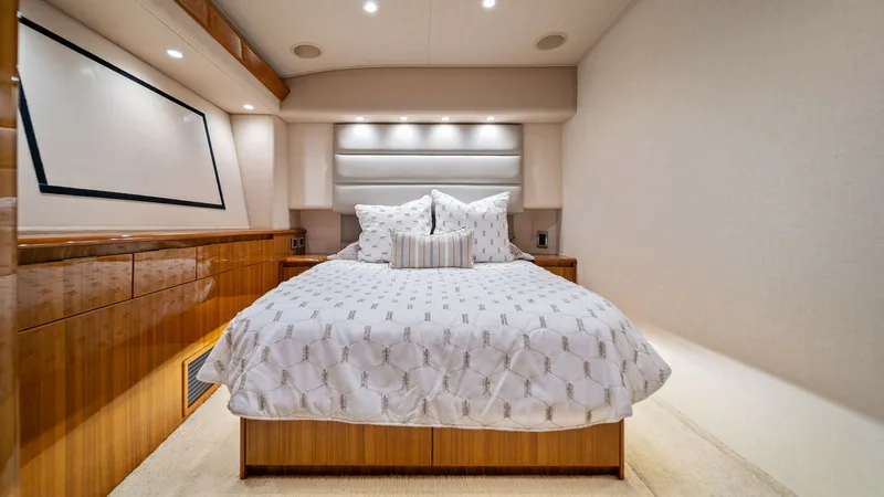 Slide: The Image of Luxurious Master Stateroom The master stateroom of the 2015 Viking 55 Convertible 'Rosita' features an inviting queen-sized berth with plush bedding. Rich wood cabinetry and ambient recessed lighting create a warm and sophisticated ambiance. The room's spacious layout and elegant f - 7584881