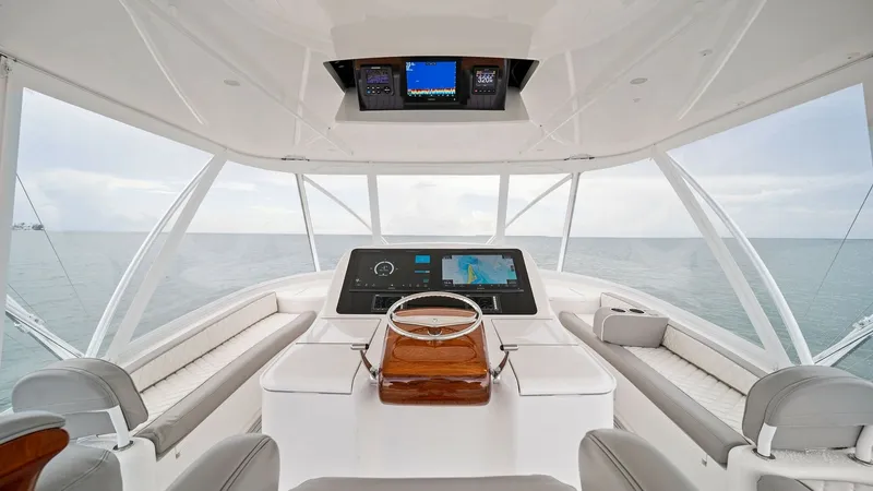 Slide: The Image of Flybridge Helm with Panoramic Views The flybridge helm of the Viking 55 Convertible offers expansive ocean views, perfect for navigation and leisure. It features a sleek, modern console with advanced navigation systems and comfortable seating for passengers. The ergonomic design and high-qu - 7584894