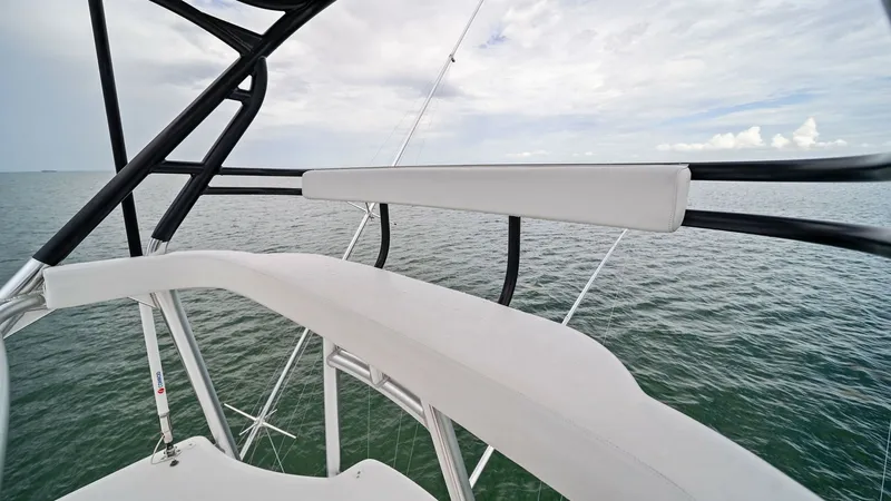Slide: The Image of Flybridge Helm Seating This image showcases the sleek flybridge helm seating area on the 2015 Viking 55 Convertible. The seating is upholstered in high-quality, weather-resistant material, offering both comfort and durability. The elevated position provides an unobstructed pano - 7584912