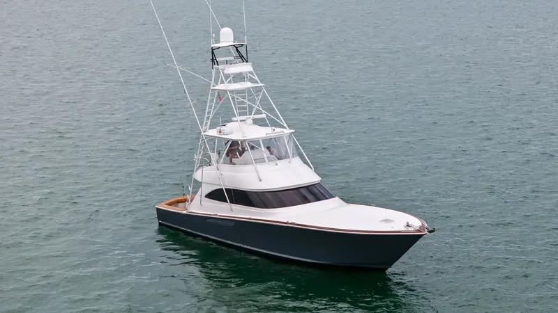 Slide: The Image of Aerial View of Viking 55 Convertible The 2015 Viking 55 Convertible 'Rosita' is showcased from an elevated angle, highlighting its sleek lines and robust tower. The yacht's spacious flybridge and distinctive hull design are crafted for both luxury and performance. With its prominent fishing - 7584932