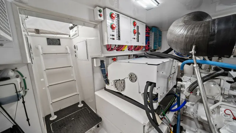 Slide: The Image of Engine Room with Control Panels This image showcases the meticulously organized engine room of the 2015 Viking 55 Convertible. Prominent features include advanced control panels and well-maintained machinery, reflecting the vessel's commitment to performance and reliability. The bright - 7584919