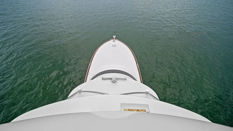 Slide: The Image of Bow View from Flybridge This image captures the sleek bow of the 2015 Viking 55 Convertible, viewed from the flybridge. The clean lines and aerodynamic design enhance both performance and aesthetic appeal. The expansive view over the water showcases the yacht's capability for ex - 7584914