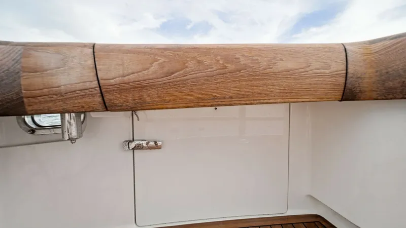 Slide: The Image of Cockpit Coaming and Teak Deck This image showcases the Viking 55 Convertible's cockpit, featuring a robust wooden coaming that adds a touch of elegance and durability. The teak deck beneath offers a classic nautical feel, providing both aesthetic appeal and practical grip. Ideal for a - 7584856