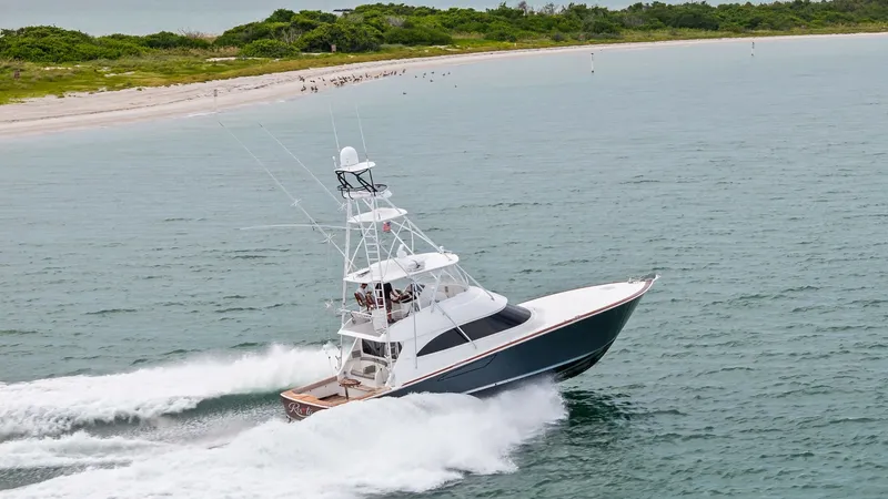 Slide: The Image of Dynamic Side View in Motion The 2015 Viking 55 Convertible, Rosita, is captured in full stride, showcasing its sleek profile and powerful performance. The vessel cuts through the water effortlessly, highlighting its robust hull design. Its towering flybridge and elegant lines make i - 7584943