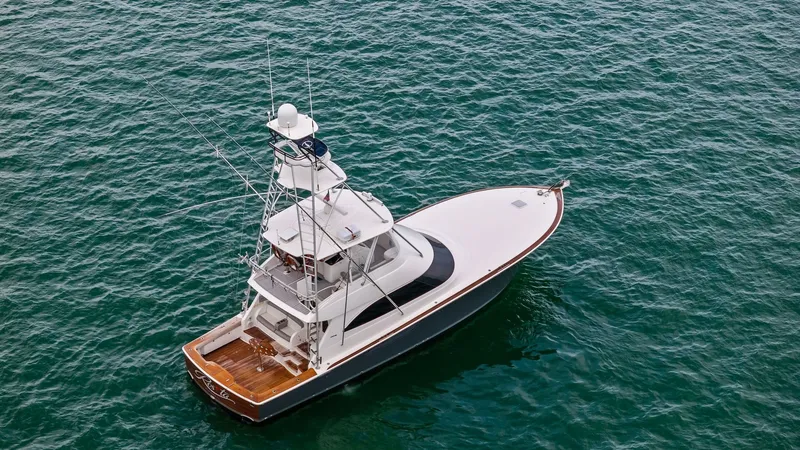 Slide: The Image of Aerial View of Upper Deck This aerial shot showcases the Viking 55 Convertible's sleek design and spacious upper deck. The flybridge is equipped with advanced navigation equipment, while the teak aft deck offers ample space for relaxation or fishing. The vessel's elegant lines and - 7584931