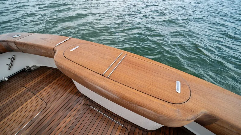 Slide: The Image of Teak Cockpit with Tackle Center This image showcases the exquisite teak cockpit of the 2015 Viking 55 Convertible, Rosita. The area features a sleek tackle center with integrated storage, ideal for fishing enthusiasts. The high-quality wood finish adds a touch of elegance, complemented - 7584857