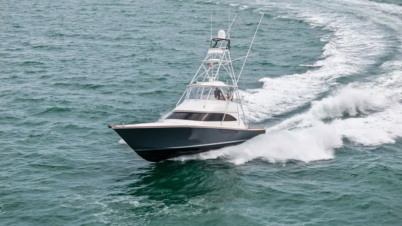 Slide: The Image of Dynamic Bow View in Motion The Viking 55 Convertible 'Rosita' showcases its sleek bow slicing through the water with impressive agility. The vessel's sharp lines and towering flybridge highlight its robust design, perfect for both sportfishing and luxury cruising. Its powerful perf - 7584941