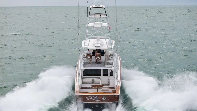Slide: The Image of Aft View with Wake Action This dynamic aft view of the 2015 Viking 55 Convertible 'Rosita' showcases its powerful performance on the open sea. The spacious cockpit is equipped with comfortable seating, perfect for enjoying the thrill of the ride. The vessel's sleek design and impr - 7584940