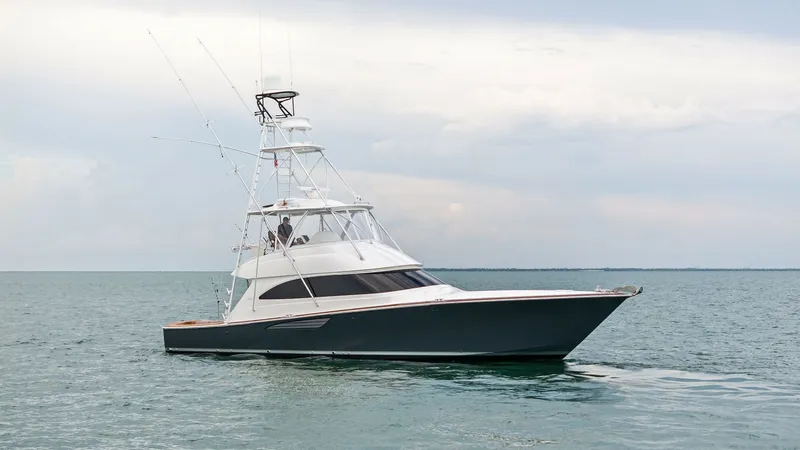 Slide: The Image of Exterior Profile of 55 Convertible This image showcases the sleek and powerful exterior profile of the 2015 Viking 55 Convertible, 'Rosita'. The vessel's hull is designed for optimal performance, slicing through the water with ease. Notable features include the commanding flybridge with to - 7584927