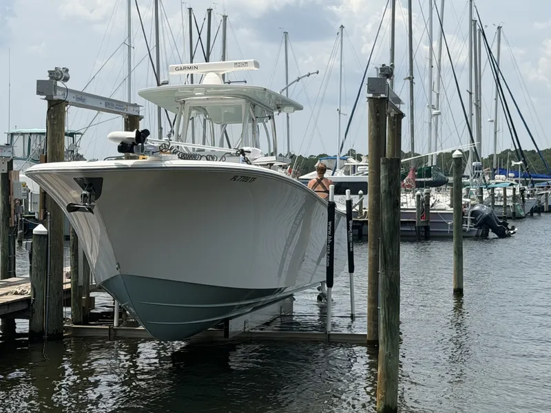 Slide: The Image of Front Runner 33 Center Console Bow Angle Front profile and bow angle dockside displaying aggressive bow flare and high freeboard for offshore capability. - 7589614