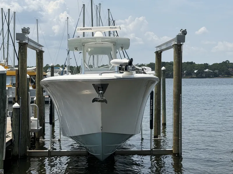 Slide: The Image of 2022 Front Runner 33 CC Dockside Dockside view highlighting the boat's beam, clean hull sides, and spacious deck layout. - 7589612