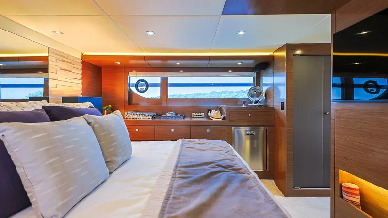 Slide: The Image of Master Stateroom with Scenic View The master stateroom of the 2020 Sol Mate offers luxurious comfort with a spacious layout. Rich wood finishes and ambient lighting create a warm, inviting atmosphere, while large windows provide stunning views of the seascape. The room features ample stor - 7661150