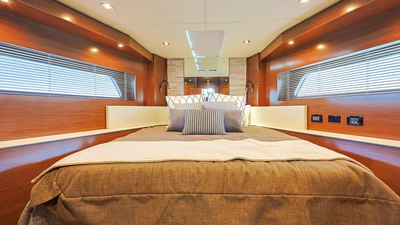 Slide: The Image of Luxurious Master Stateroom The master stateroom of the Sol Mate 60 Cantius exudes elegance with rich wood finishes and ambient recessed lighting. Large windows on either side provide natural light, enhancing the spacious feel of the room. The plush bedding and modern fixtures creat - 7661143