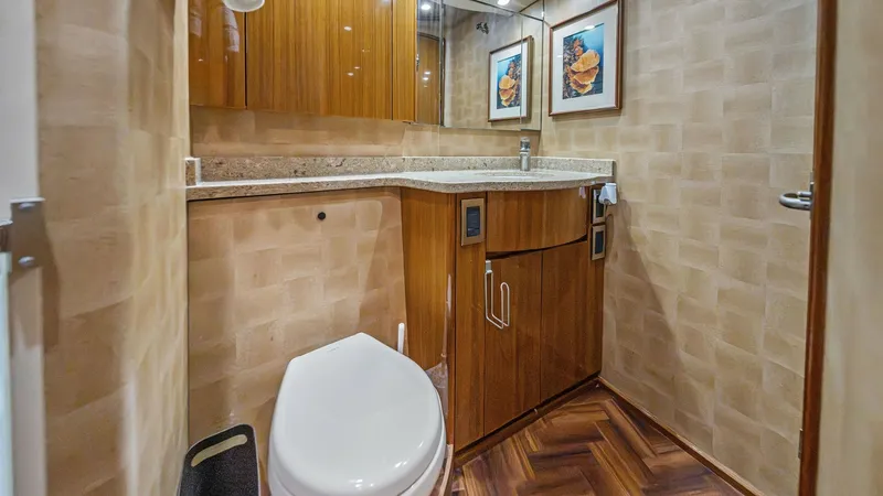 Slide: The Image of Luxurious Yacht Bathroom Interior This elegant yacht bathroom features exquisite wood cabinetry and a sleek, modern countertop. The space is complemented by stylish decor and ambient lighting, creating a sophisticated and inviting atmosphere. The high-quality materials and meticulous desi - 7962079