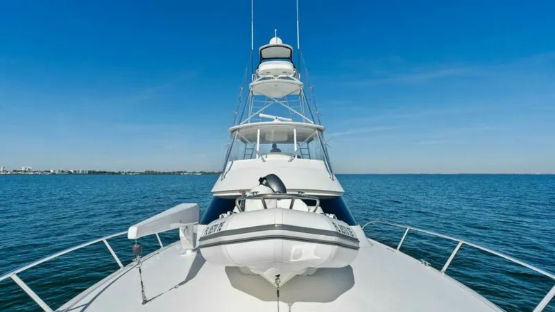 Slide: The Image of Bow View with Tower and Tender This striking image of the 2013 Viking 55 Convertible 'Hot Spot' showcases the sleek bow area with a neatly secured tender. The towering flybridge offers commanding views, ideal for spotting fish or enjoying panoramic seascapes. The clean lines and spacio - 7594285