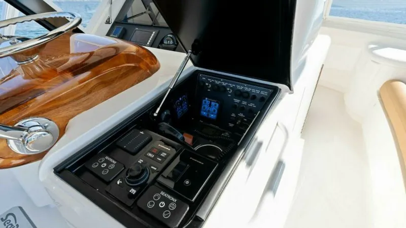 Slide: The Image of Helm Station Control Panel This image showcases the sophisticated helm station control panel of the Viking 55 Convertible. Featuring a sleek, high-gloss wooden steering console, the panel is equipped with state-of-the-art navigation and communication systems. The ergonomic layout e - 7594278