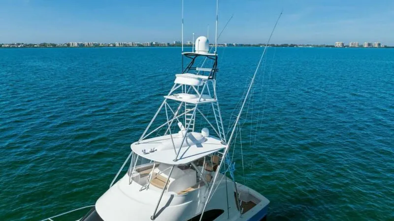 Slide: The Image of Flybridge and Tuna Tower View This image showcases the impressive flybridge and tuna tower of the 2013 Viking 55 Convertible. The sleek design and advanced electronics are evident, offering excellent visibility and control for navigating open waters. The tower provides an elevated van - 7594270