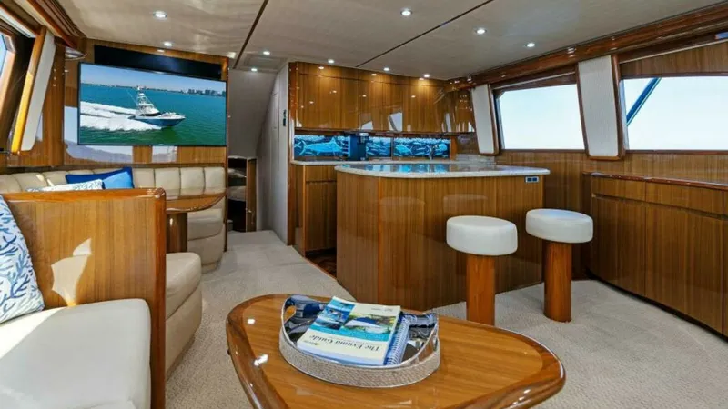 Slide: The Image of Luxurious Salon and Galley This elegant salon on the 2013 Viking 55 Convertible features plush seating and a state-of-the-art entertainment system. The open layout flows seamlessly into the galley, showcasing rich wood finishes and modern appliances. Large windows provide ample nat - 7594237