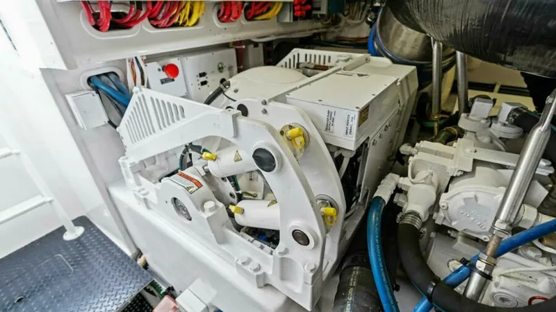 Slide: The Image of Engine Room with Generator View This image showcases the well-organized engine room of the 2013 Viking 55 Convertible, featuring a robust generator. The layout highlights easy access to essential components, with neatly arranged wiring for efficient maintenance. The pristine condition r - 7594294