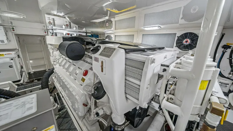 Slide: The Image of Engine Room with Twin Engines The engine room of the Viking 55 Convertible 'Hot Spot' showcases well-maintained twin engines, emphasizing power and reliability. The space is impeccably organized with high-quality components and efficient layout, ensuring optimal performance. Bright li - 7962105