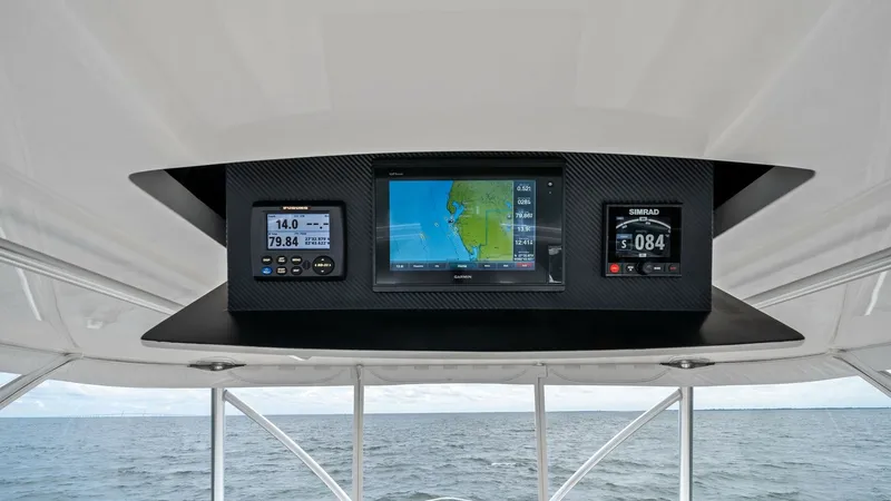 Slide: The Image of Flybridge Electronics Console The flybridge electronics console of the 2013 Viking 55 Convertible showcases advanced navigation technology. Featuring a large central display flanked by multifunctional instruments, this setup ensures precision and ease of use for the captain. The carbo - 7962098