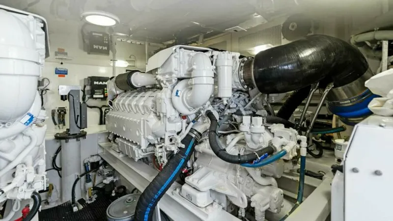 Slide: The Image of Engine Room with Twin Engines The engine room of the 2013 Viking 55 Convertible 'Hot Spot' showcases powerful twin engines. The space is meticulously organized, featuring high-quality components and efficient layout for optimal performance. Clean and well-maintained, it provides easy - 7594292