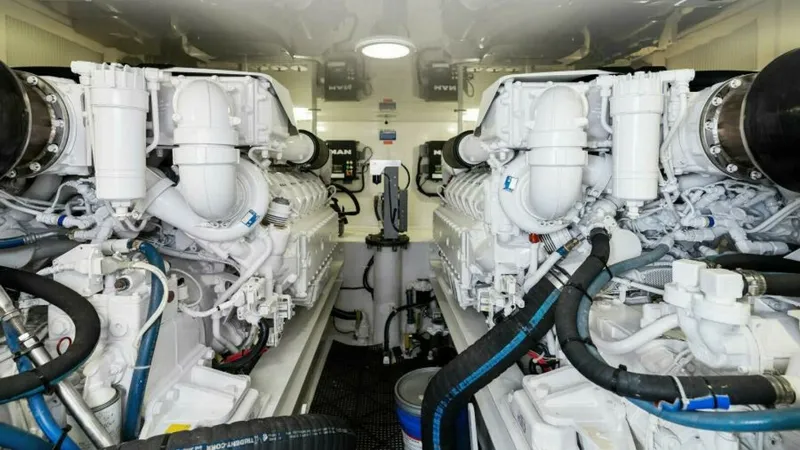 Slide: The Image of Engine Room with Twin Engines The engine room of the 2013 Viking 55 Convertible 'Hot Spot' showcases powerful twin engines, meticulously maintained for optimal performance. The space is organized and well-lit, highlighting the advanced engineering and clean layout. This area ensures e - 7594291
