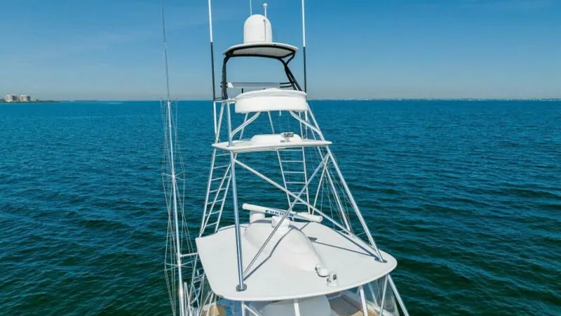 Slide: The Image of Flybridge and Tower View This image showcases the striking tower and flybridge of the 2013 Viking 55 Convertible, offering a commanding view over the open water. The tower is equipped with advanced radar and communication systems, ensuring safe and efficient navigation. The sleek - 7594269