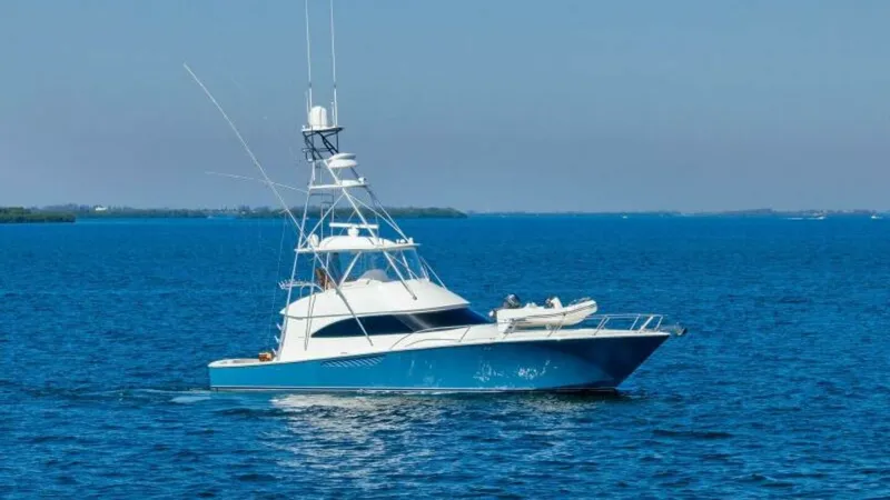 Slide: The Image of Viking 55 Convertible Side View The 2013 Viking 55 Convertible 'Hot Spot' gracefully navigates open waters, showcasing its sleek design and robust structure. The yacht's striking blue hull complements the expansive flybridge, equipped with advanced communication antennas. Perfect for bo - 7594301
