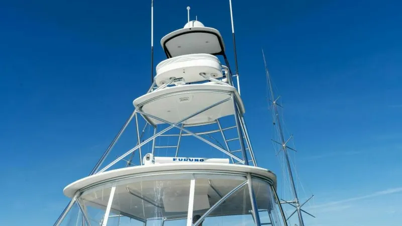 Slide: The Image of Tower with Flybridge and Antennas The Viking 55 Convertible's tower showcases a well-equipped flybridge, offering excellent visibility for navigation and fishing. The robust structure is fitted with advanced communication and navigation antennas, ensuring reliable performance at sea. The - 7594268