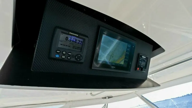 Slide: The Image of Flybridge Navigation Station The flybridge of the 2013 Viking 55 Convertible features a sophisticated navigation station. Equipped with state-of-the-art electronics, including a GPS display and multi-function screen, it ensures precise navigation and control. The sleek, carbon-fiber - 7594275