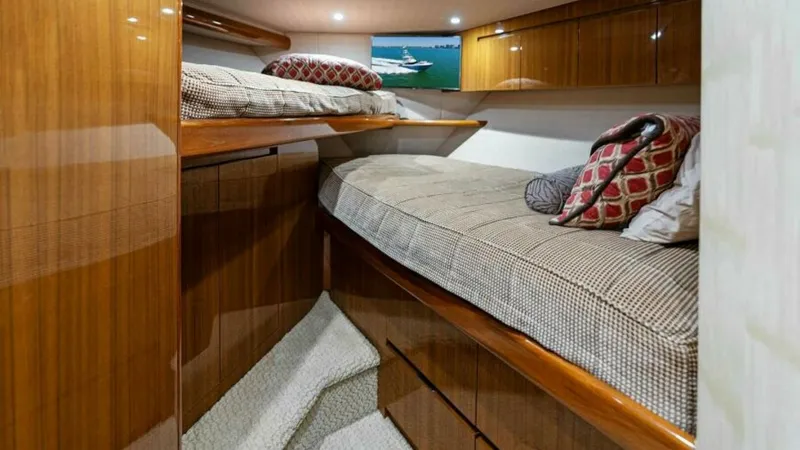 Slide: The Image of Guest Stateroom with Bunk Beds This cozy guest stateroom features comfortable bunk beds, perfect for accommodating extra guests. The rich wood finishes and plush bedding create a warm and inviting atmosphere. Ample storage is available beneath the lower bunk, optimizing space and funct - 7594251
