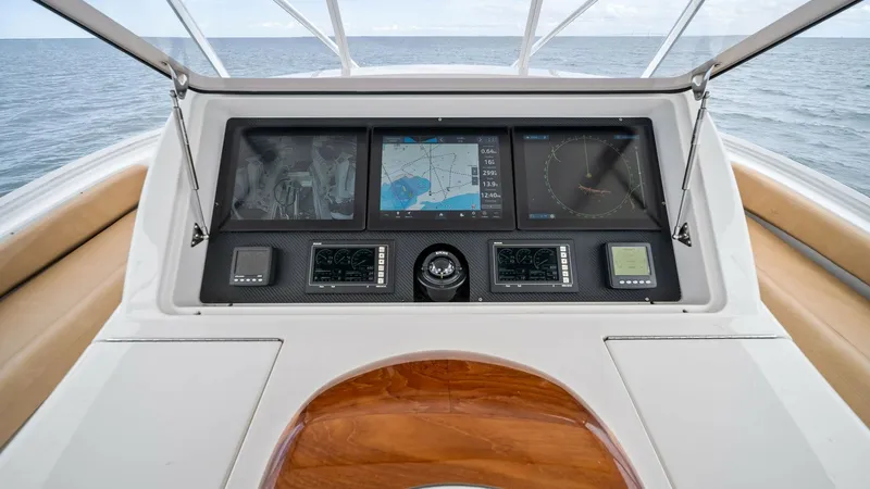 Slide: The Image of Flybridge Helm Station with Electronics The helm station on the Viking 55 Convertible 'Hot Spot' features a sleek array of modern electronic displays, providing comprehensive navigation and control. The rich wood accents and ergonomic layout ensure a stylish and functional command center. Expan - 7962097