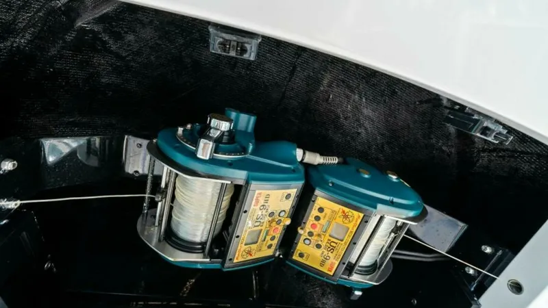 Slide: The Image of Fishing Reel Storage Compartment This image showcases the fishing reel storage compartment on the Viking 55 Convertible, 'Hot Spot'. The compartment is designed for easy access and secure storage, featuring robust reels ready for deep-sea fishing. The sleek design and practical layout hi - 7594279