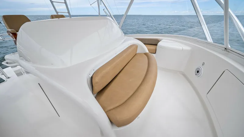 Slide: The Image of Flybridge Helm Seating Area The flybridge helm of the 2013 Viking 55 Convertible offers a sleek and modern design with its smooth white surfaces and tan cushioned seating. This area provides a comfortable vantage point for navigation, with ample space for relaxing while enjoying pan - 7962102