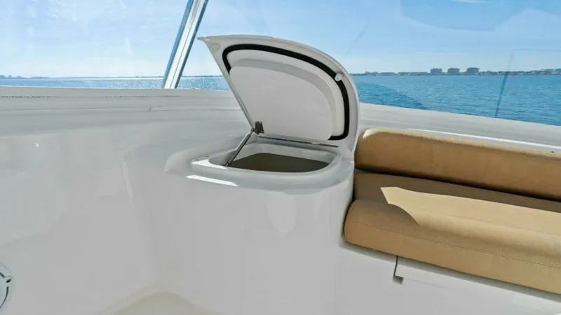 Slide: The Image of Flybridge Seating with Storage Hatch This image showcases the flybridge seating area of the 2013 Viking 55 Convertible. The comfortable bench seating is complemented by a convenient storage hatch, perfect for stowing gear or refreshments. The area offers stunning views of the open water, enh - 7594261