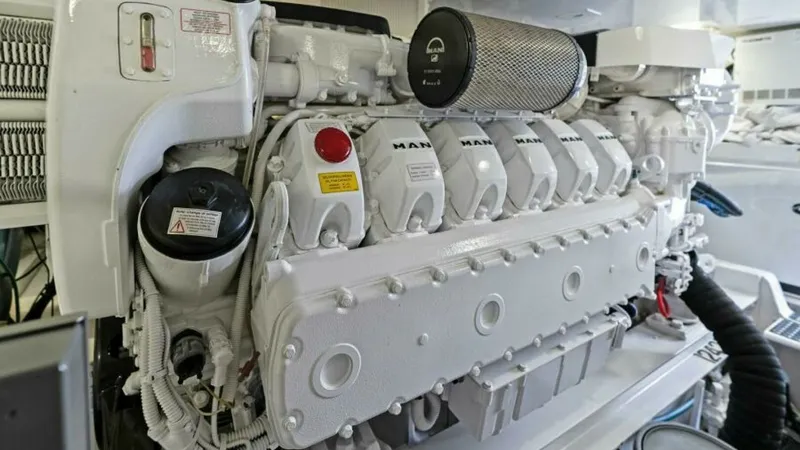 Slide: The Image of Engine Room with MAN Engine The engine room of the 2013 Viking 55 Convertible showcases a powerful MAN engine, meticulously maintained and presented in pristine condition. The robust engineering promises reliability and performance, essential for extended voyages. The well-organized - 7594295