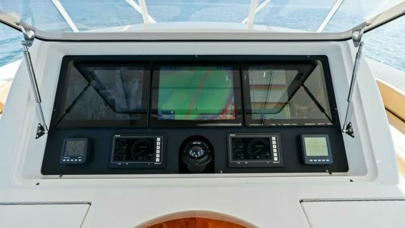 Slide: The Image of Helm Station with Navigation Displays The helm station of the 2013 Viking 55 Convertible 'Hot Spot' features state-of-the-art navigation displays, providing seamless control and monitoring. The sleek dashboard integrates multiple screens and gauges, ensuring a comprehensive overview for the c - 7594276