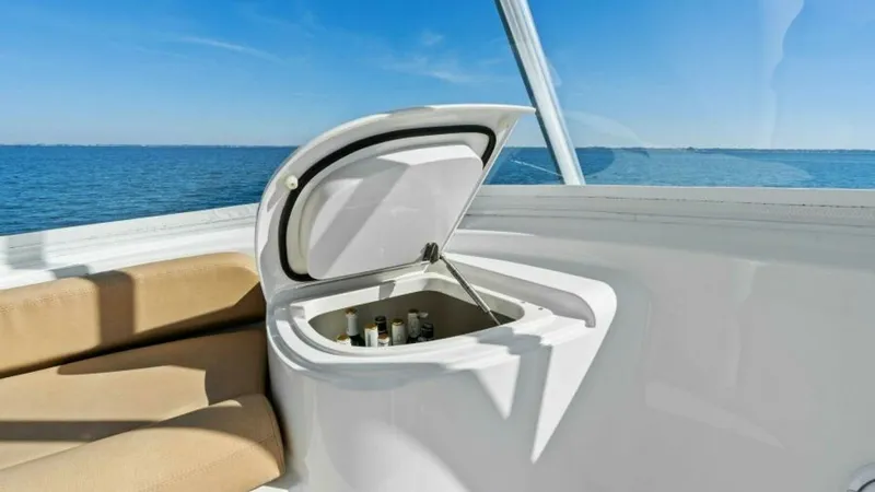 Slide: The Image of Flybridge Beverage Station This image showcases the flybridge beverage station on the 2013 Viking 55 Convertible. The built-in cooler is conveniently positioned next to comfortable seating, offering easy access to refreshments while enjoying panoramic ocean views. The sleek design - 7594260