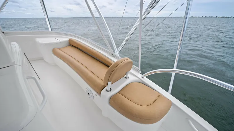 Slide: The Image of Flybridge Seating with Ocean View This image showcases the comfortable flybridge seating on the 2013 Viking 55 Convertible. The plush, tan cushions provide ample space for relaxation while enjoying panoramic ocean views. The sleek, white finish and sturdy railing enhance both safety and s - 7962101