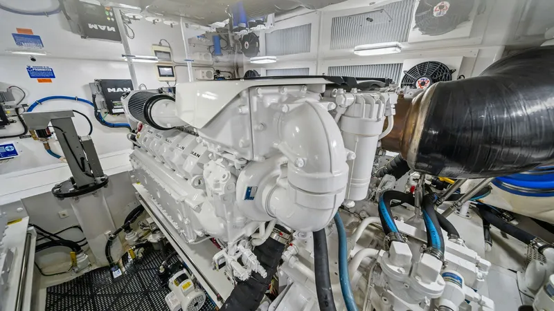Slide: The Image of Engine Room with MAN Engines The engine room of the 2013 Viking 55 Convertible 'Hot Spot' showcases powerful MAN engines, engineered for performance and efficiency. It features a meticulously organized layout, with well-maintained components and accessible systems. The space is well- - 7962110