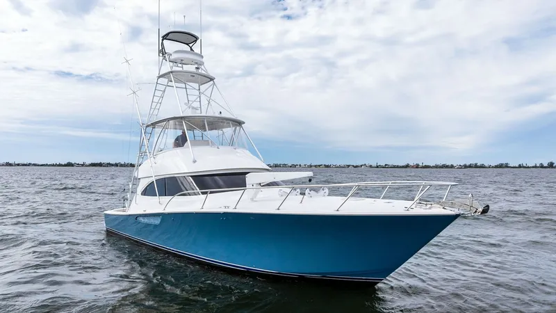 Slide: The Image of Bow View of Viking 55 Convertible The sleek and powerful bow of the 2013 Viking 55 Convertible cuts through the water with ease, showcasing its striking blue hull and polished stainless-steel bow rail. The expansive flybridge tower offers commanding visibility, ideal for navigation and sp - 7962112