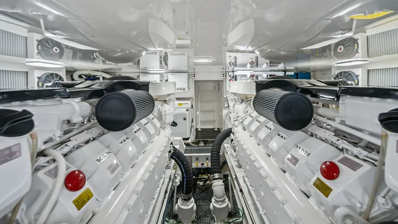Slide: The Image of Engine Room with Twin Engines This image showcases the meticulously maintained engine room of the 2013 Viking 55 Convertible, featuring powerful twin engines. The layout is spacious, allowing easy access for maintenance and operations. The pristine condition and state-of-the-art engin - 7962103