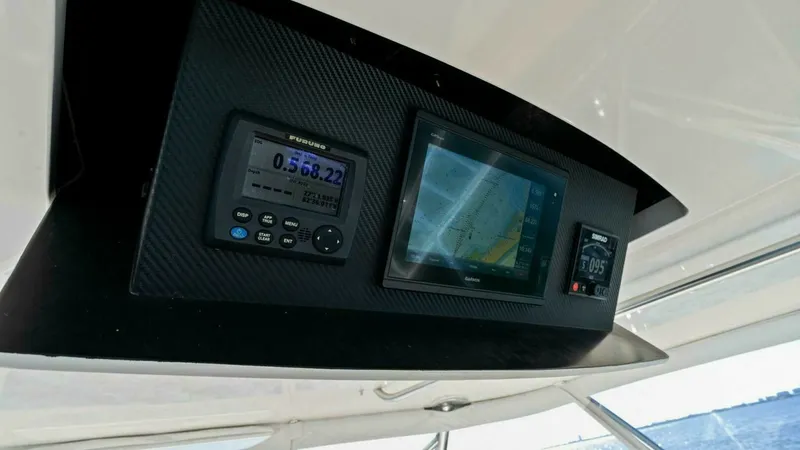 Slide: The Image of Flybridge Navigation Console The 2013 Viking 55 Convertible's flybridge features a state-of-the-art navigation console with sophisticated electronic displays. The console includes multi-function displays for GPS and chart plotting, ensuring precise navigation. Its sleek design and in - 7594290