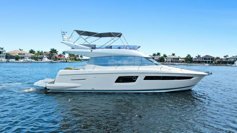 Slide: The Image of Side Profile of Prestige 500 Fly The side profile of the 2015 Prestige 500 Fly showcases its sleek and modern design. With expansive windows and a streamlined hull, this yacht offers elegant aesthetics and optimal natural light. The flybridge is equipped with a spacious seating area, per - 7603828