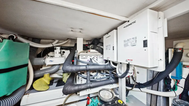 Slide: The Image of Engine Room with Equipment Overview This image showcases the well-organized engine room of the 2015 Prestige 500 Fly, highlighting the sophisticated Dometic systems in place. The space is efficiently arranged with essential components and piping, ensuring optimal functionality and easy main - 7603825
